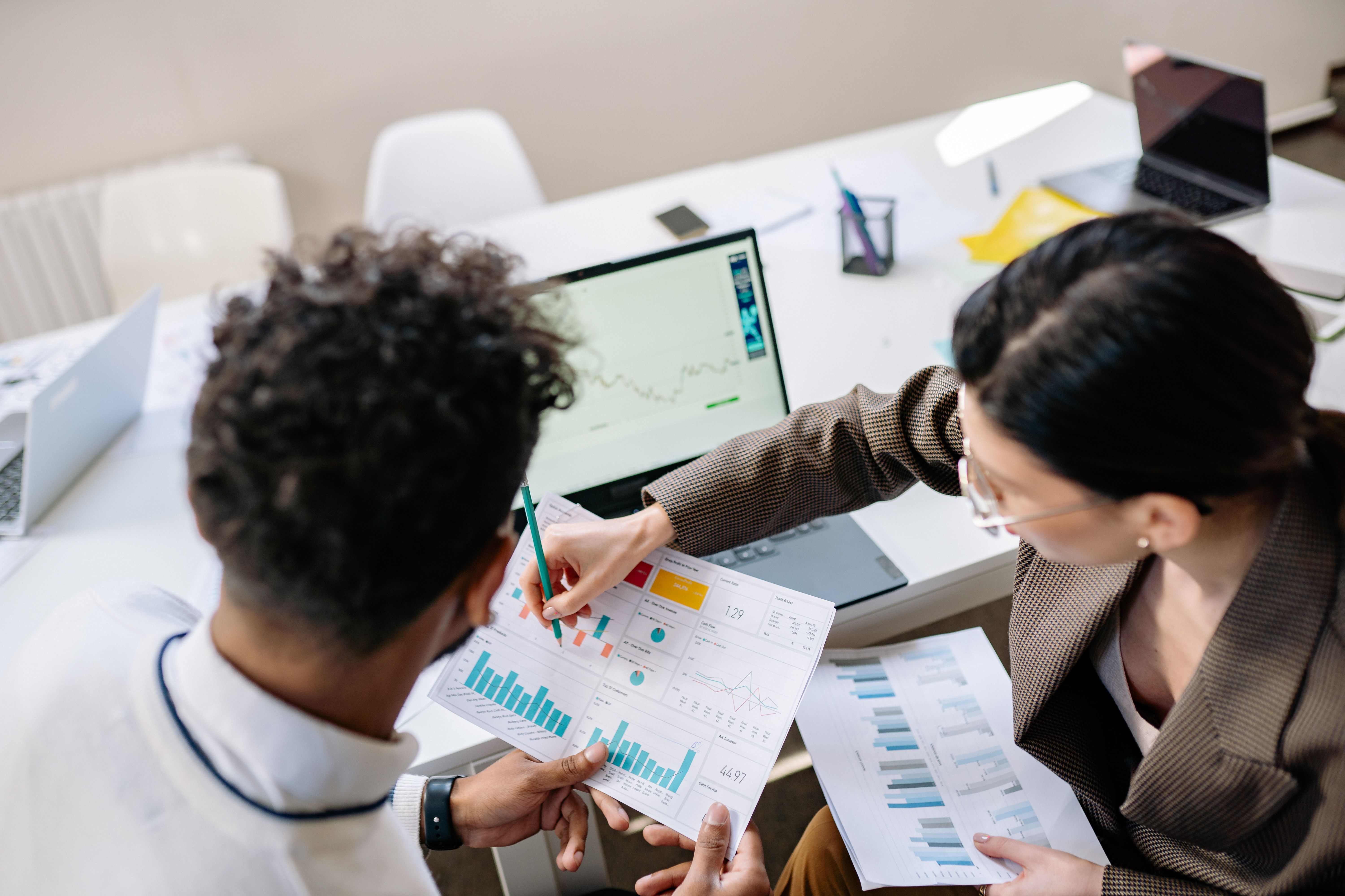 Researchers reviewing charts and reports together